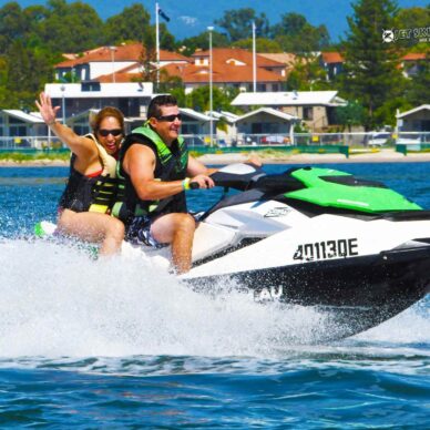 A Couple Riding a Green Jet Ski