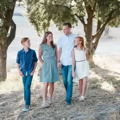 A Happy Family Walking Past by the Park