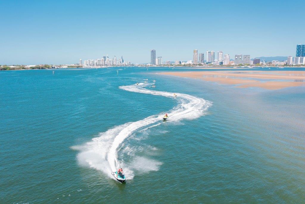 drone shot of skis passing sandbank