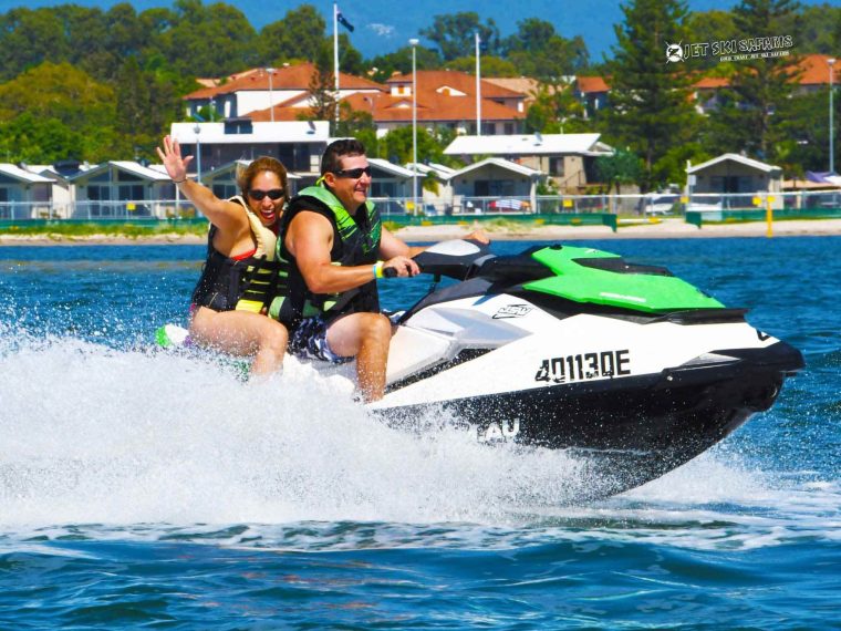 A Couple Riding a Green Jet Ski
