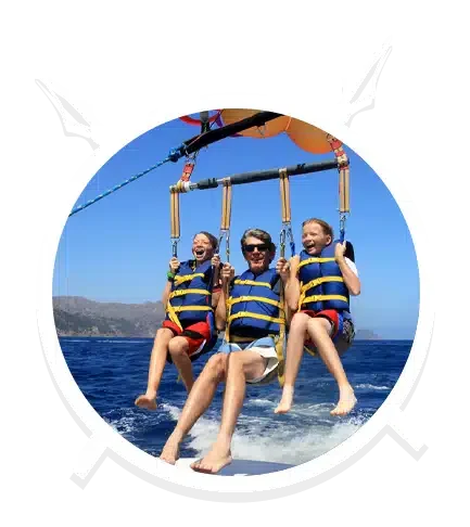 A Father and Daughters in Triple Parasailing in Main Beach, QLD
